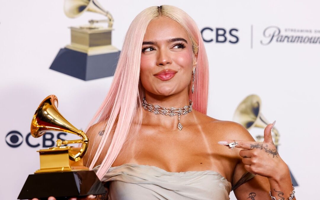 Person holding Grammy award, posing at event