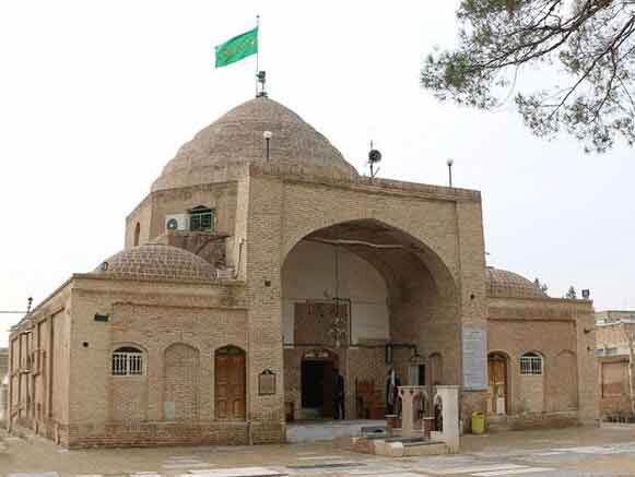 Historical building with domed roof and entrance arch.