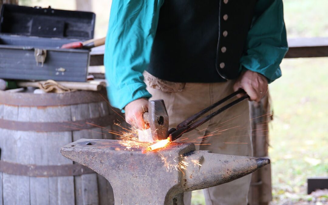 Blacksmith working on an anvil with sparks flying.