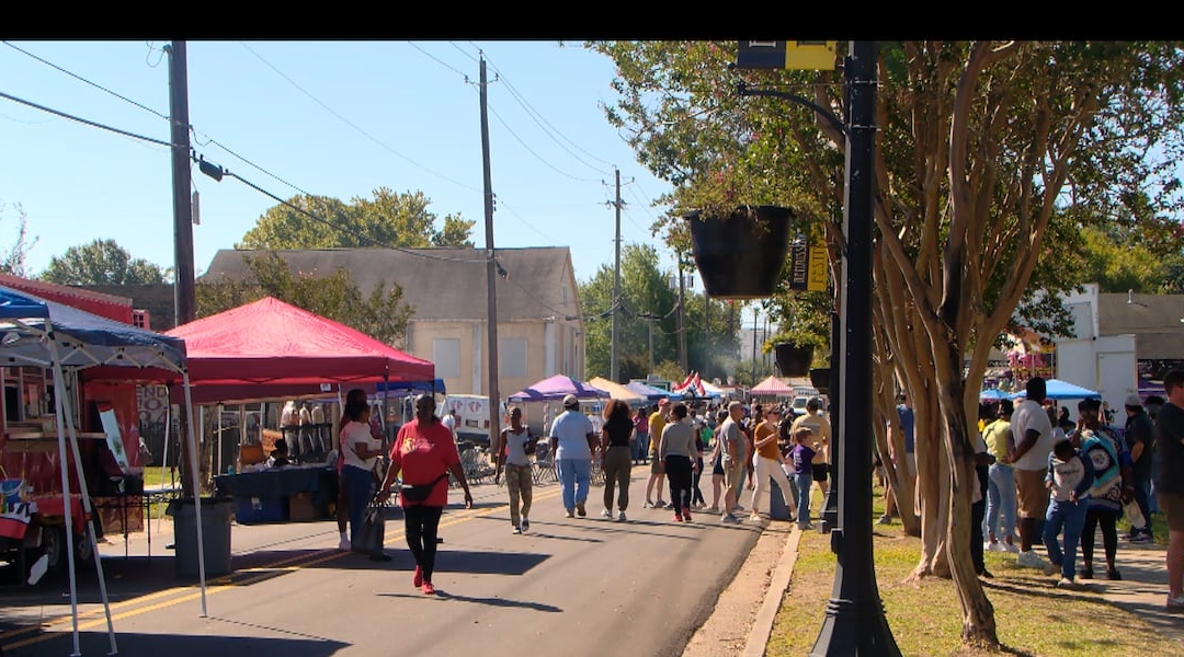 People at a colorful outdoor festival.
