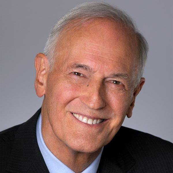 Smiling elderly man in suit portrait.