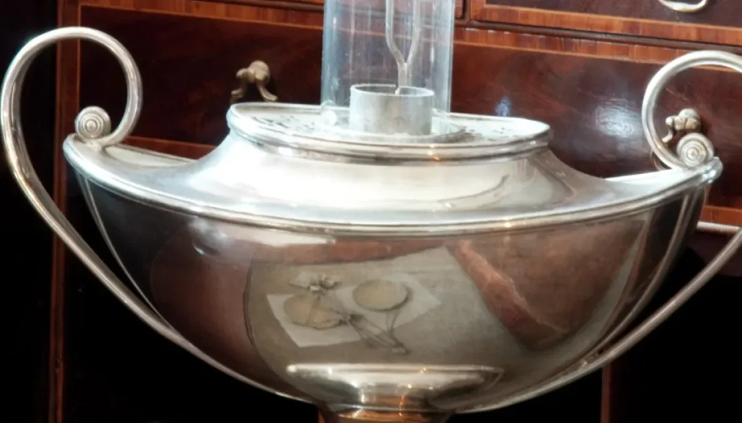 Silver tea urn with cylindrical glass chimney
