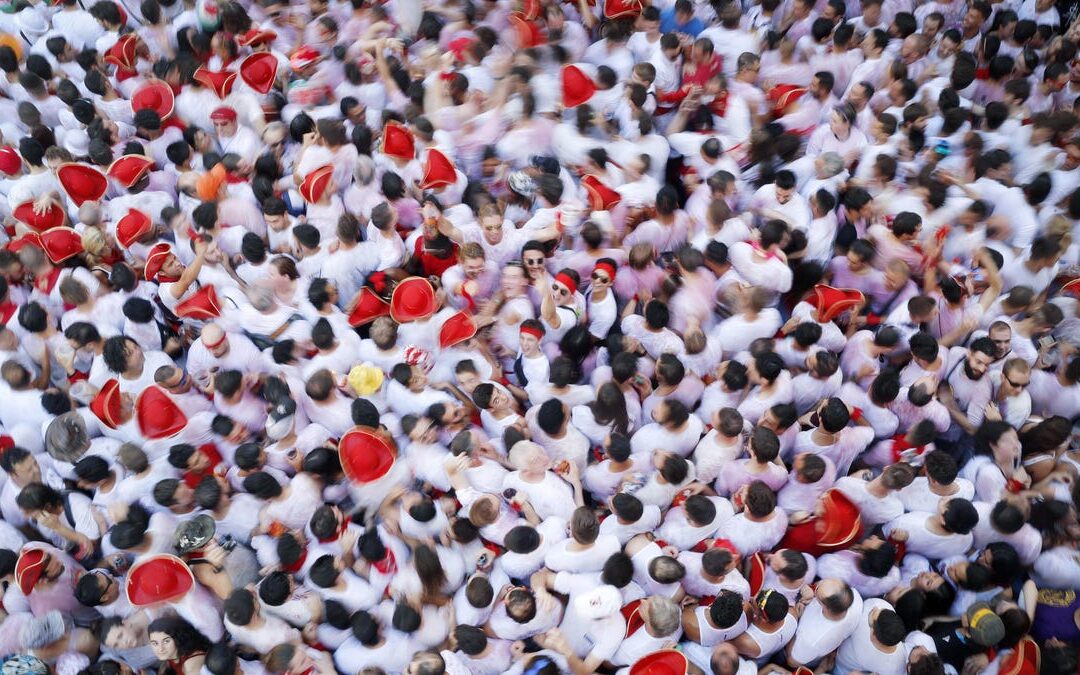 Crowd at festive event, wearing red and white.