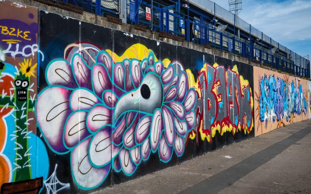 Colorful graffiti on urban wall with floral designs.