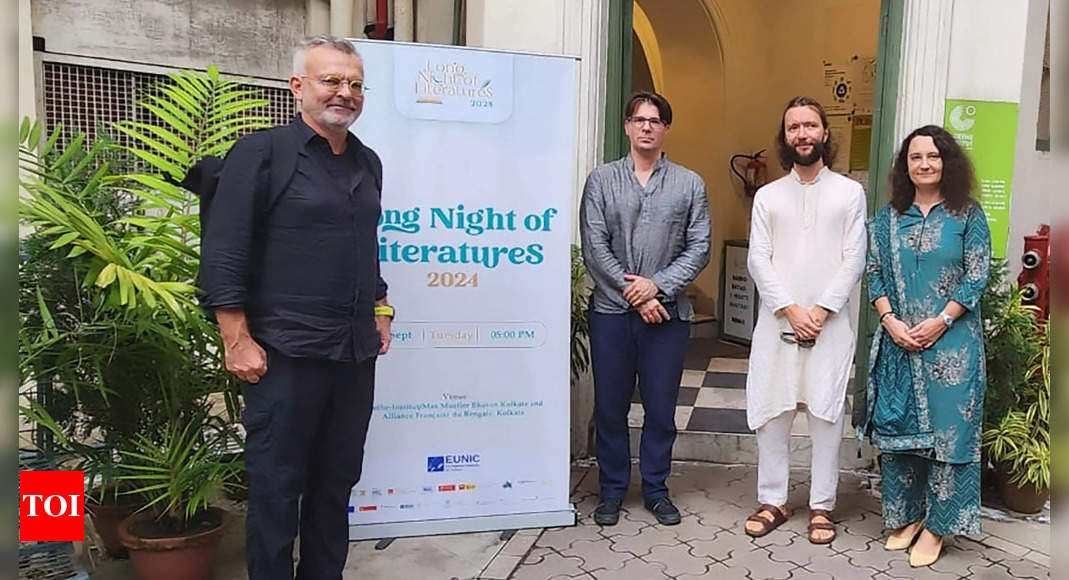 People standing next to literature event sign
