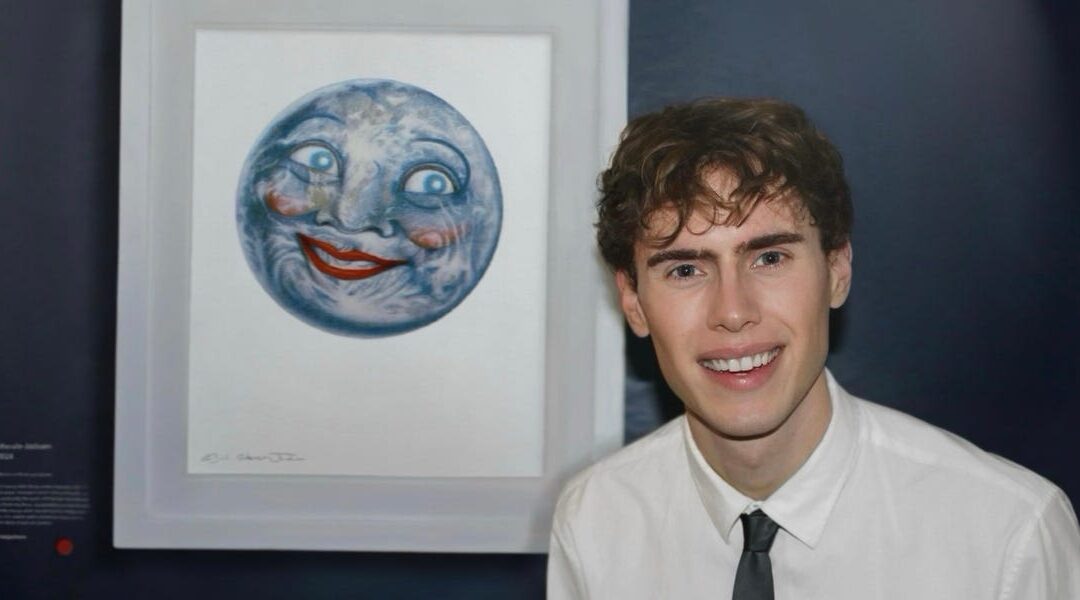 Person smiling beside artwork of face on moon.