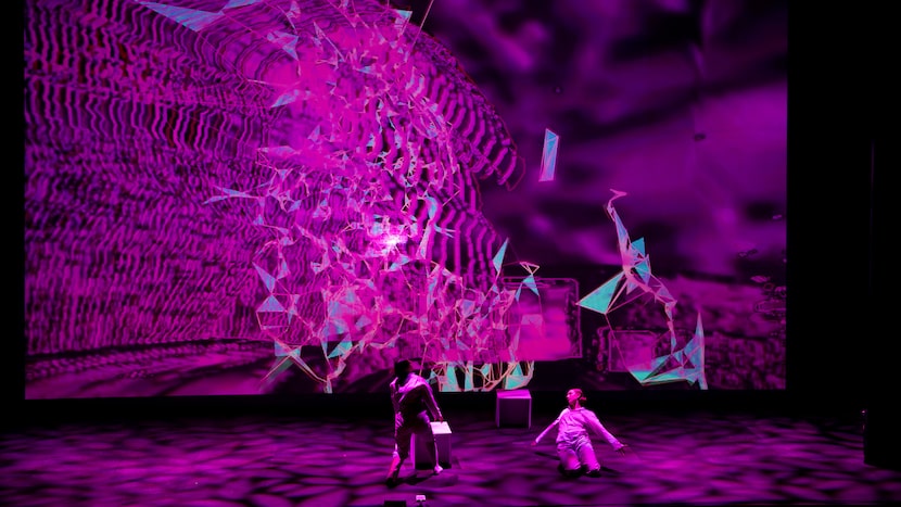 Abstract digital art with performers and vivid lighting.