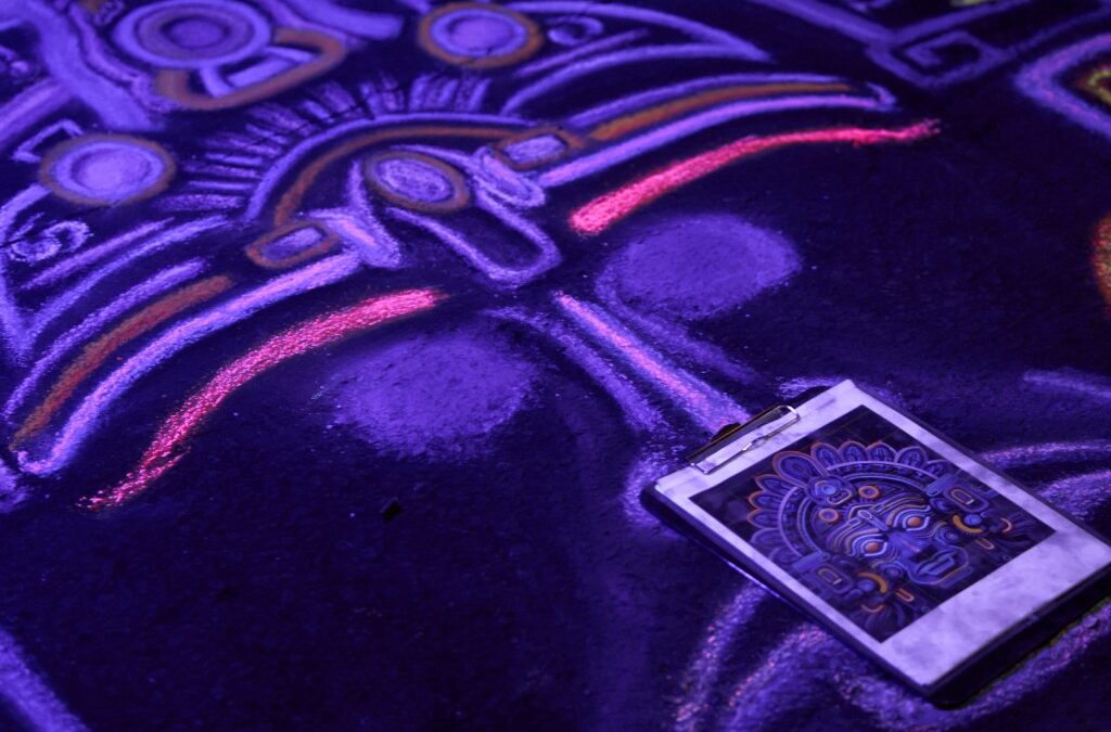 Colorful Aztec chalk drawing under UV light