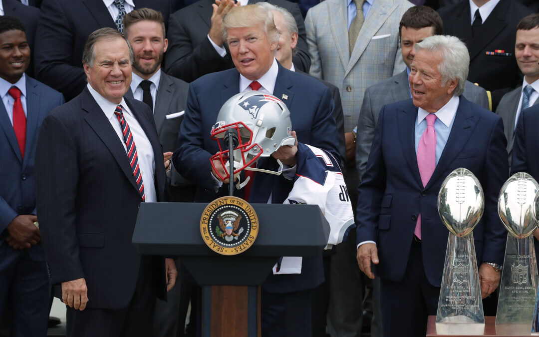Event with New England Patriots and trophies displayed.