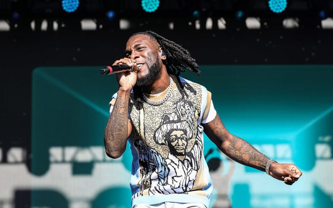 Singer performing live on stage with microphone.