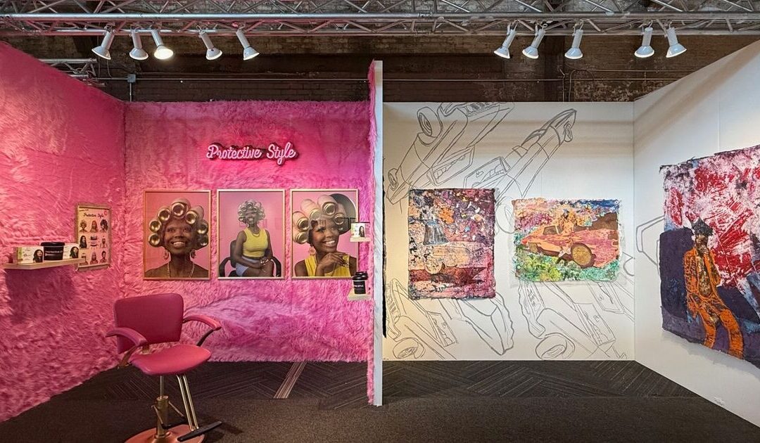 Colorful art exhibit with pink and vibrant paintings.