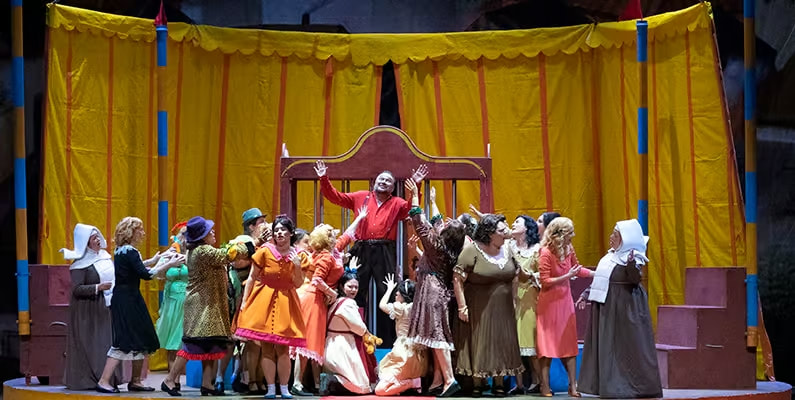 Colorful stage performance with actors in vibrant costumes.