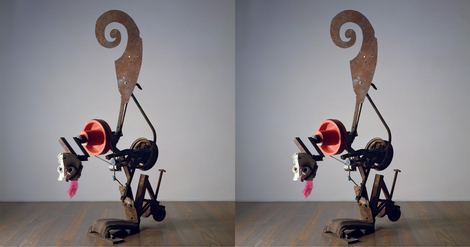 Abstract metal sculpture on wooden floor.