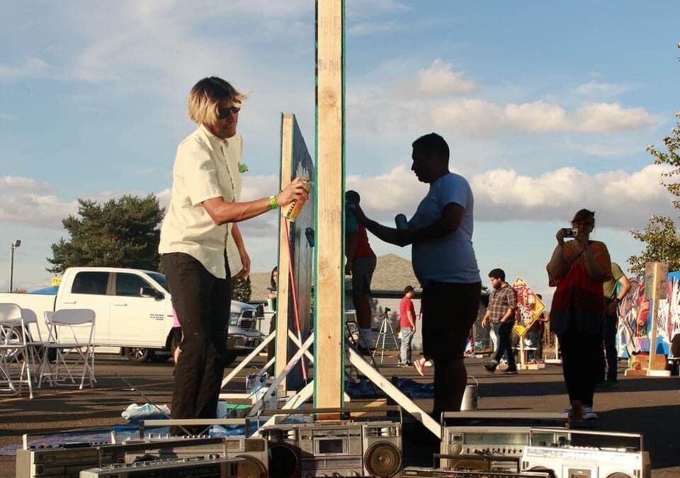 Outdoor art event with artists and stereo equipment