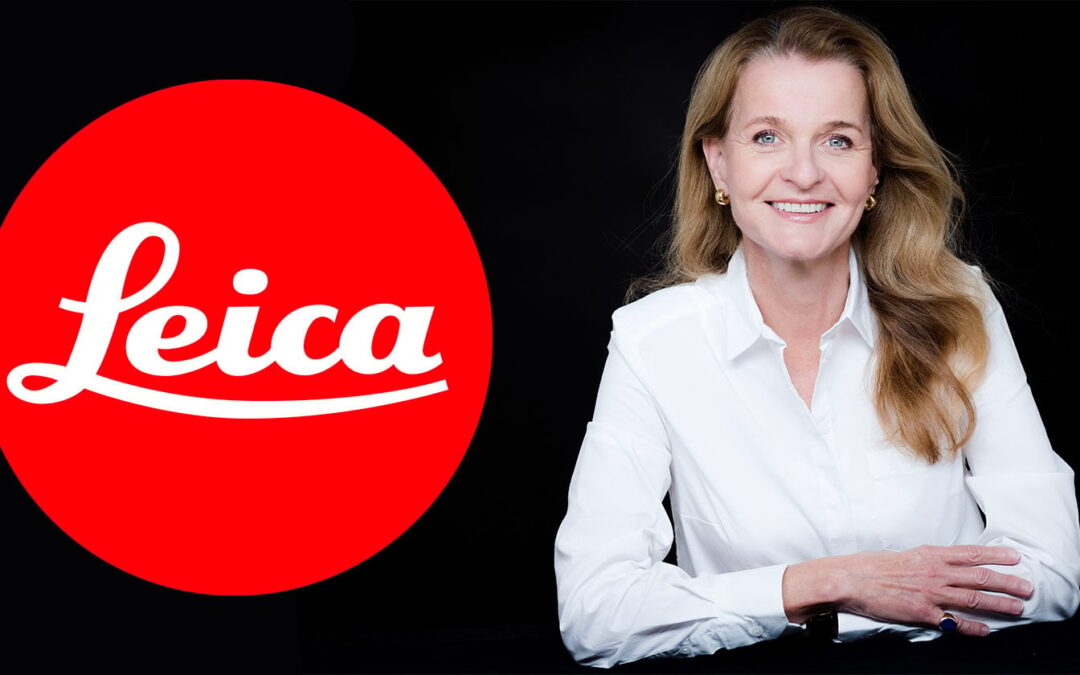 Smiling woman next to Leica logo.