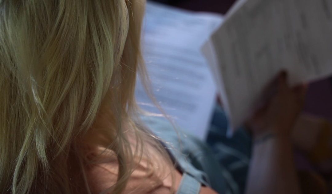 Person reading documents in dim light