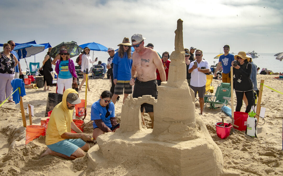 People building sandcastle on the beach