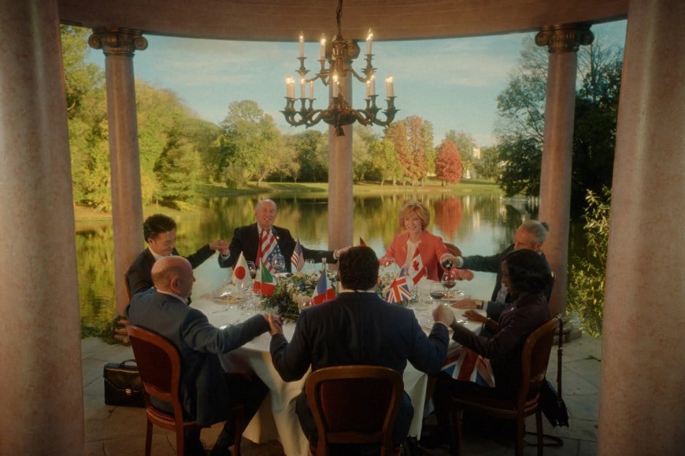 World leaders toasting at elegant outdoor dinner meeting.
