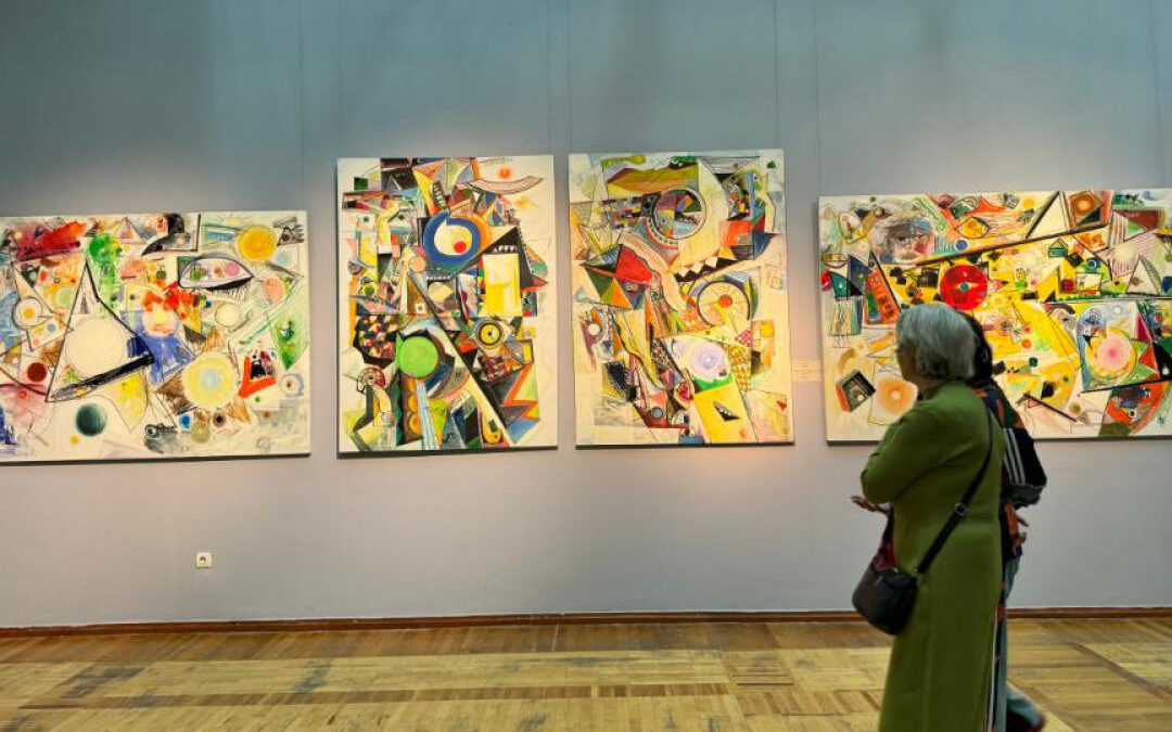 Woman observing abstract art gallery paintings