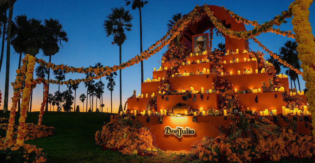 Illuminated altar with candles and flowers at sunset