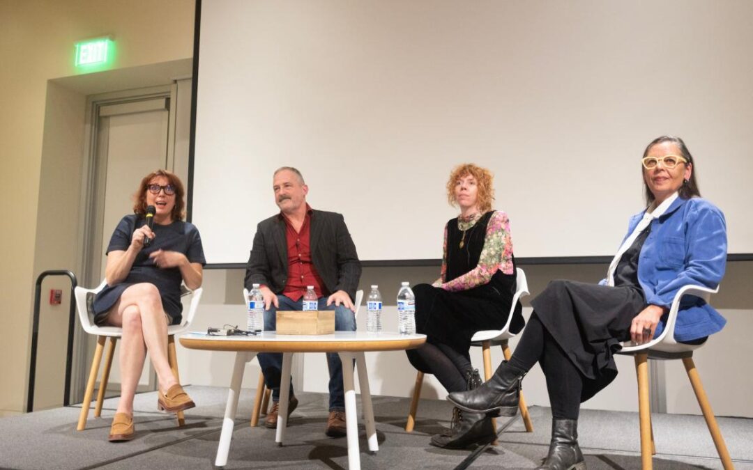 Four people speaking on a panel discussion.