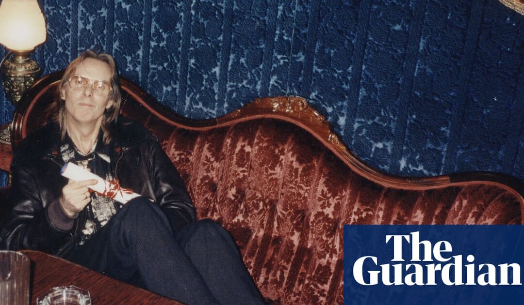 Person sitting on vintage couch with book