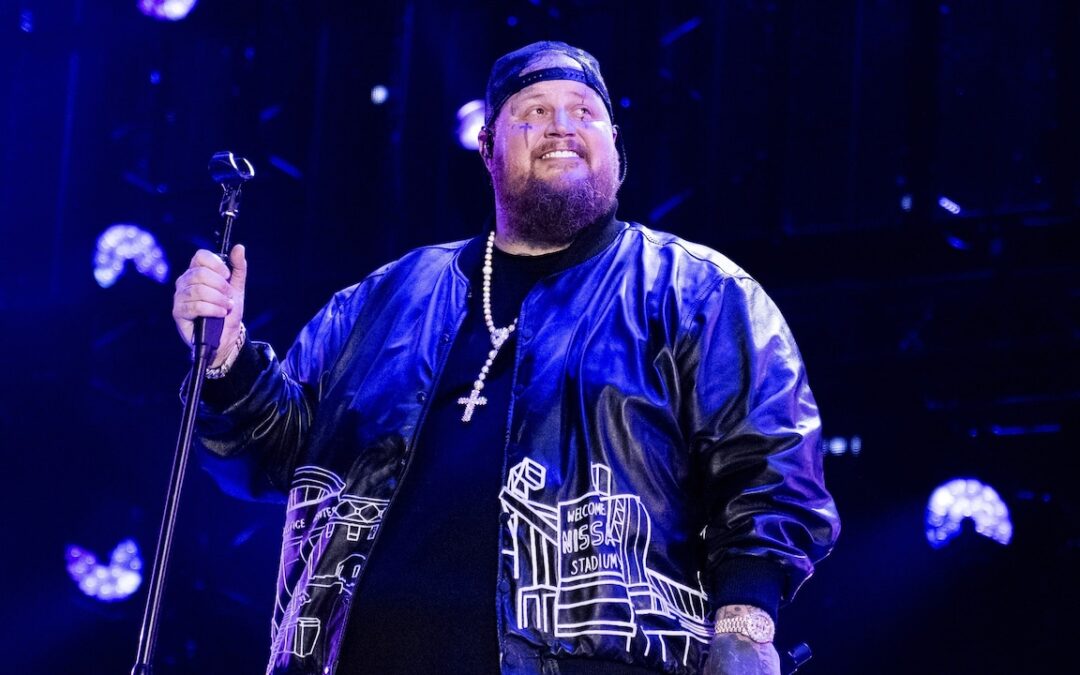 Singer performing on stage with microphone.