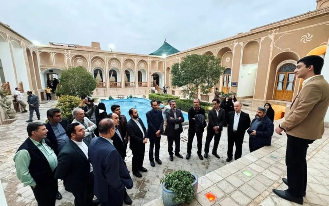 Group meeting in courtyard with pool and arches.