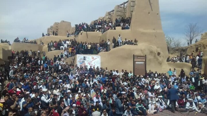 Large crowd gathered at historic site in Afghanistan.
