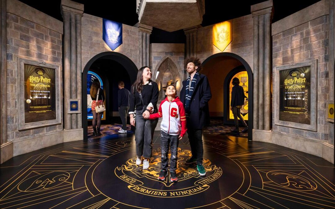 Family exploring Harry Potter exhibition entrance.