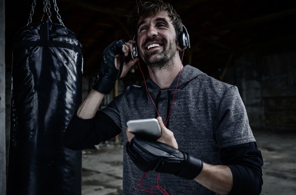 Man smiling, listening to music during workout.