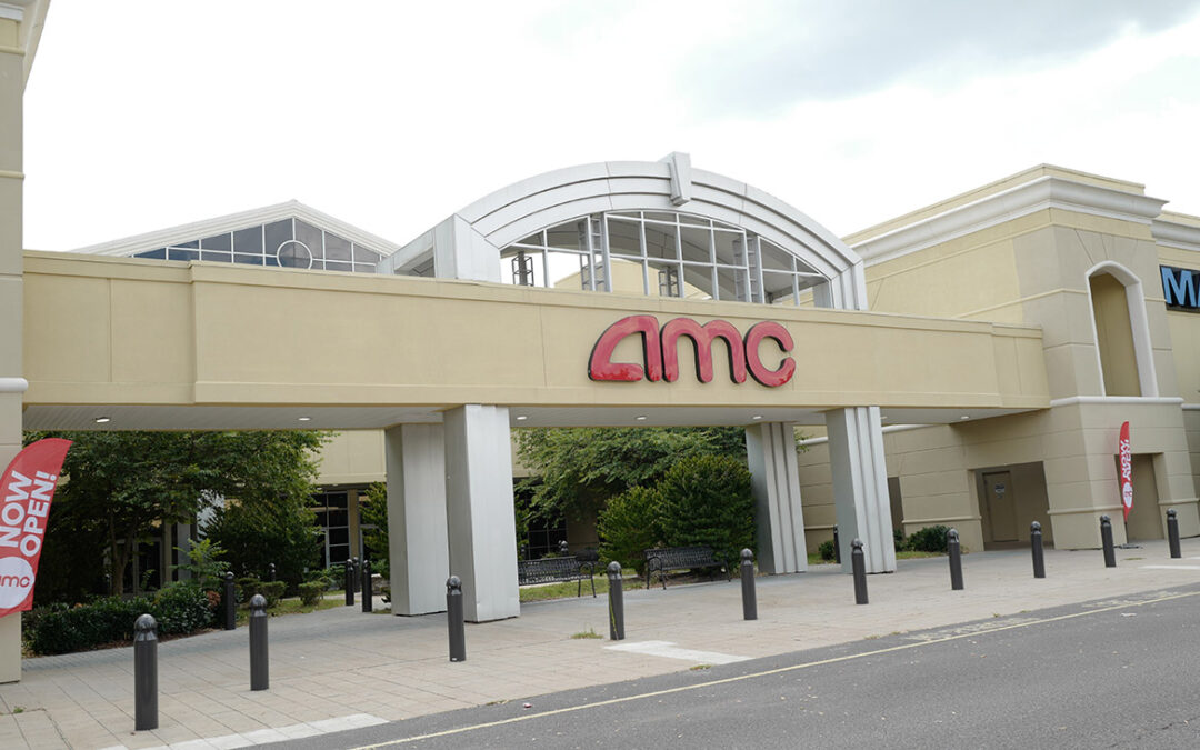 AMC movie theatre entrance, now open signs visible.