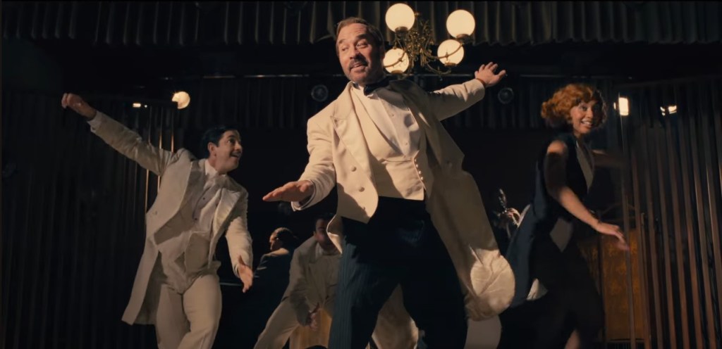 People dressed elaborately, dancing enthusiastically on stage.