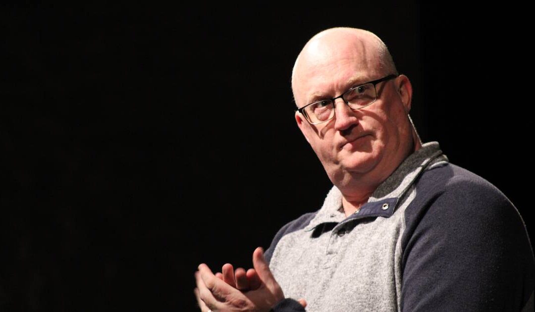 Person looking thoughtful on a stage