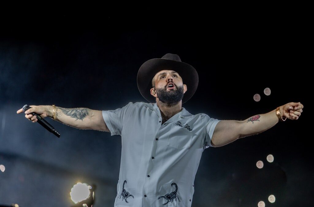 Singer performing on stage with microphone.