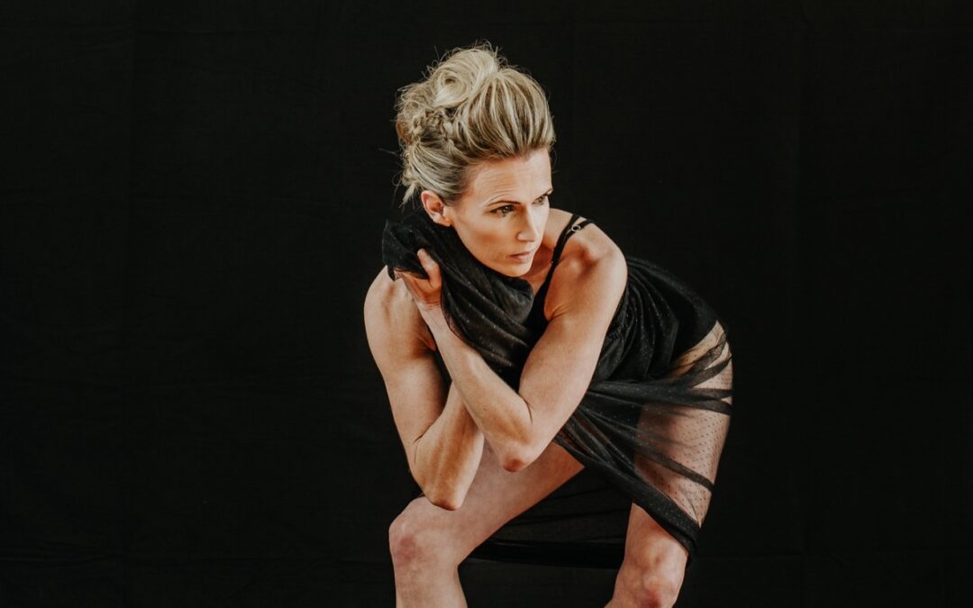 Woman wearing black dress in dramatic pose