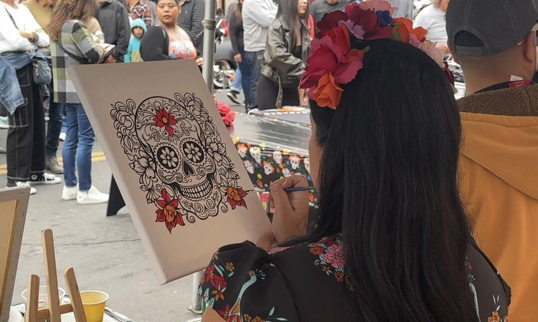 Artist painting sugar skull at festival
