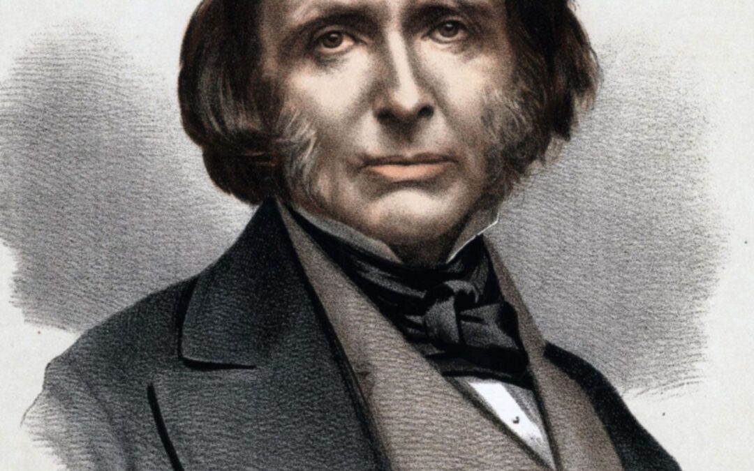 Portrait of a man with sideburns in suit.
