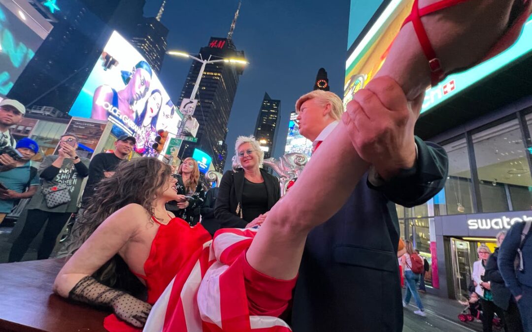 Times Square street performers entertain crowd at night.