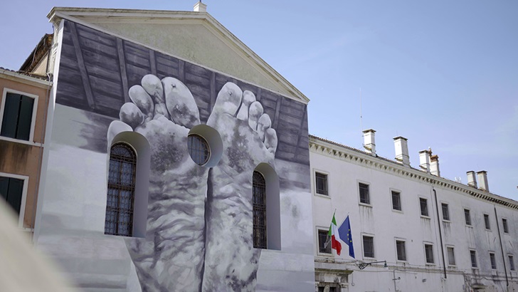 Building mural with large feet artwork