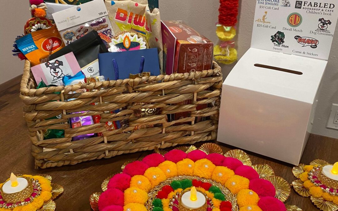 Diwali raffle basket with colorful decorations and candles.
