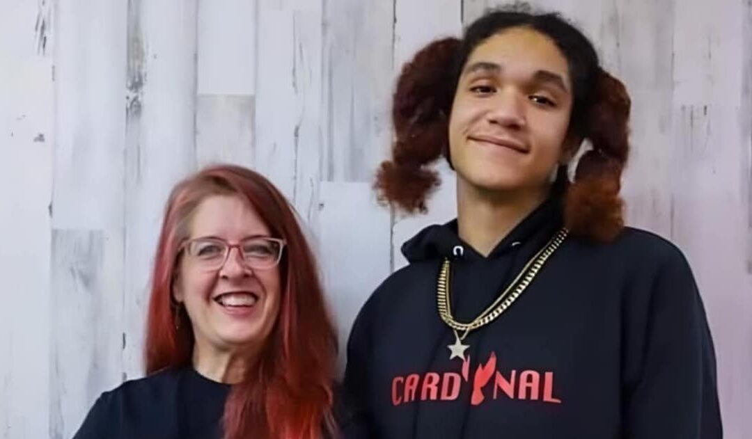 Smiling woman and young man posing together.