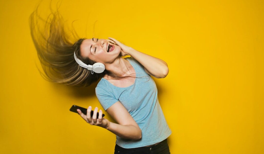 Woman enjoying music with headphones and phone