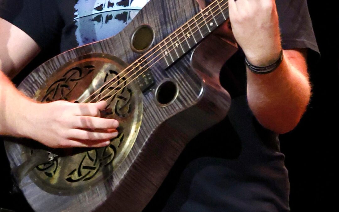 Close-up of musician playing acoustic guitar