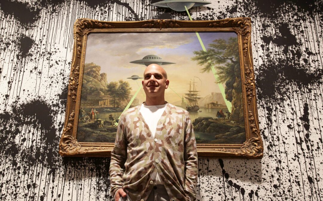 Man standing in front of UFO painting.