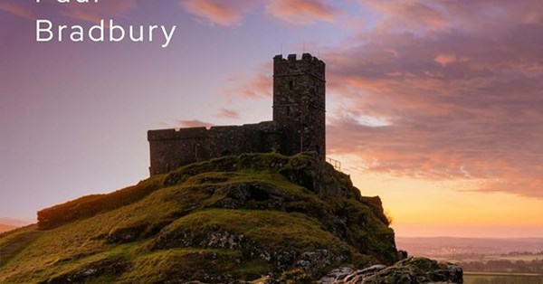 Stone tower on hill during sunset