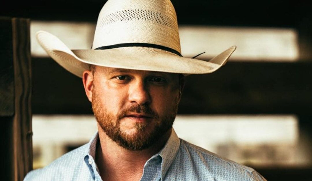 Man wearing cowboy hat and shirt.