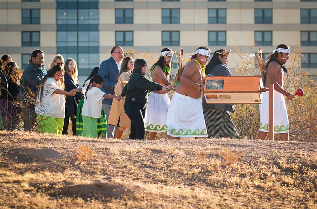 Cultural procession with traditional attire and instruments.