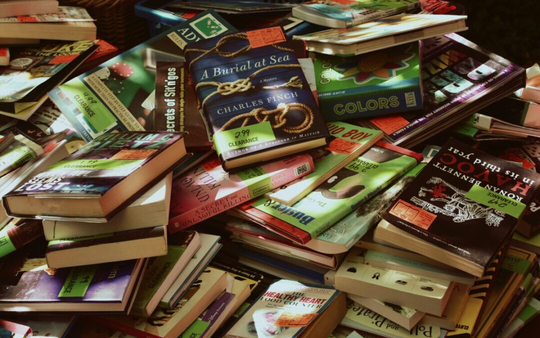 Stacked books at a clearance sale.