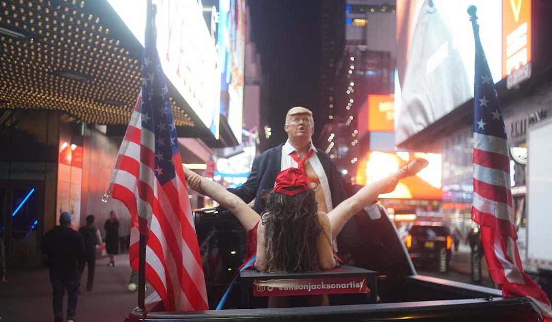 Person with flags in city scene at night.
